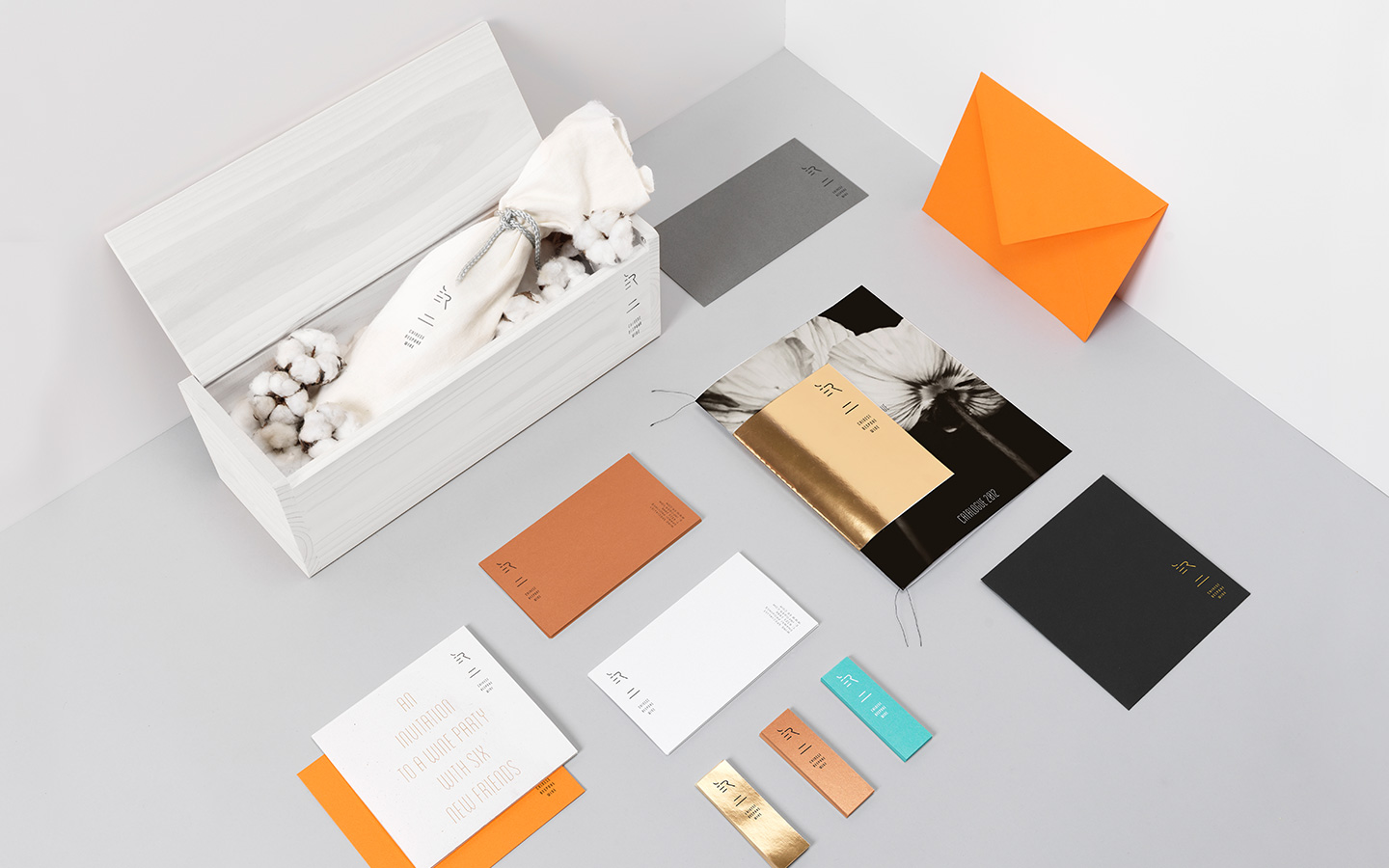 A presentation box wrapped in cotton, with printed cards and envelopes